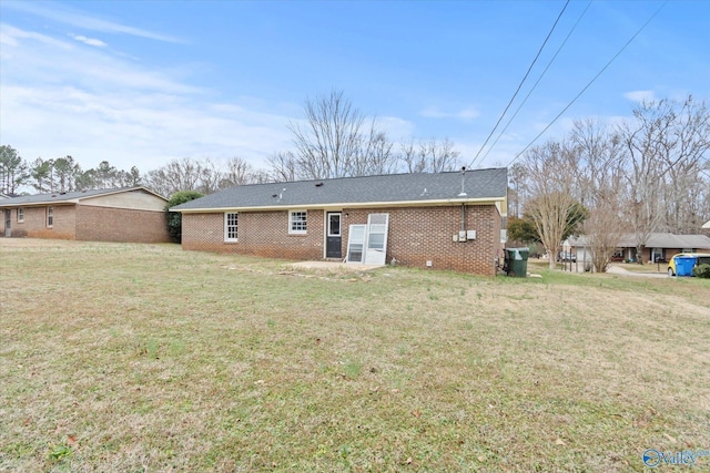 rear view of house with a yard and a patio