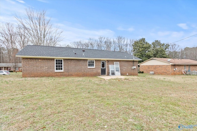 rear view of house with a lawn