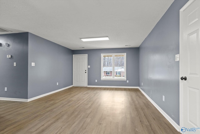 empty room featuring hardwood / wood-style floors and a textured ceiling