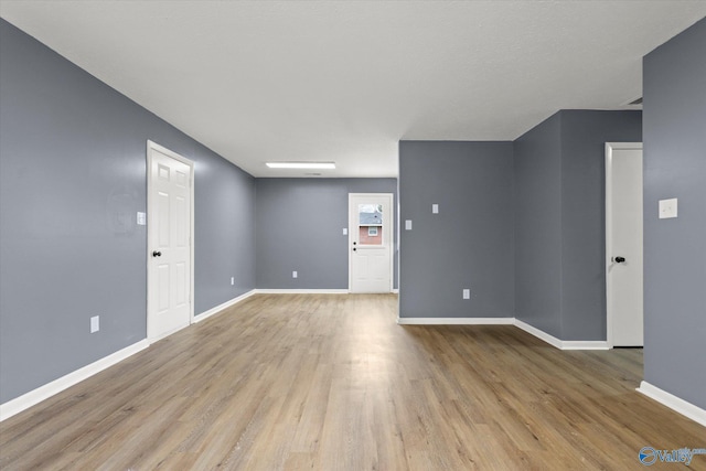 spare room with light hardwood / wood-style flooring