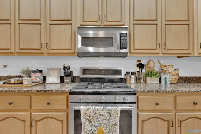 kitchen with tasteful backsplash, appliances with stainless steel finishes, stone countertops, and light brown cabinets