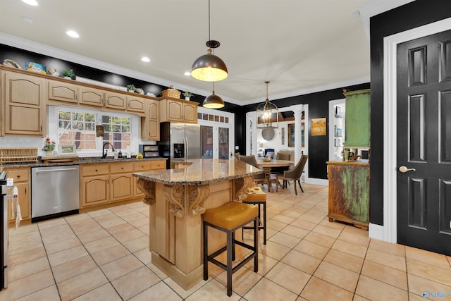 kitchen with light tile patterned flooring, a center island, dark stone counters, and appliances with stainless steel finishes