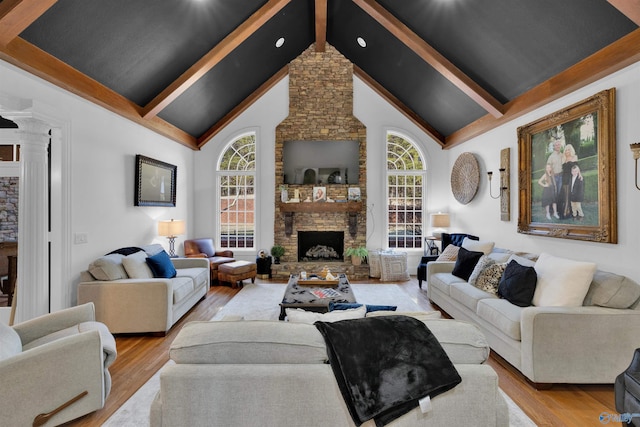 living room with a fireplace, light hardwood / wood-style floors, and plenty of natural light