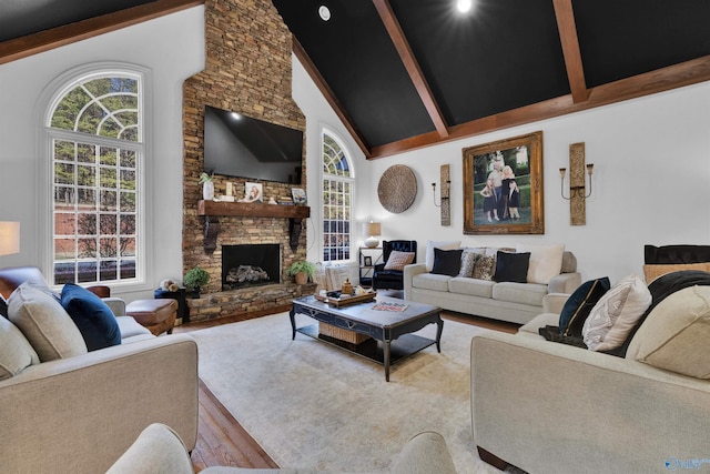 living room with high vaulted ceiling, a fireplace, light hardwood / wood-style floors, and beamed ceiling