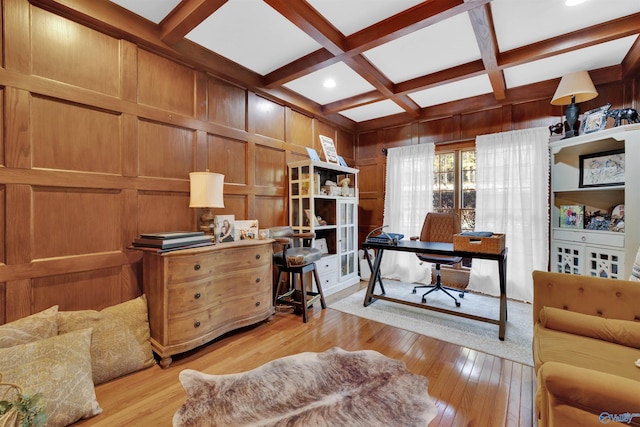 office space with coffered ceiling, wood walls, beam ceiling, and light hardwood / wood-style flooring