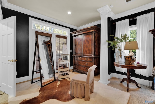 foyer entrance with ornate columns and crown molding