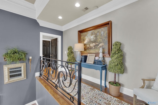 hallway with hardwood / wood-style floors and crown molding