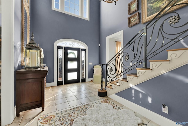 tiled entrance foyer with a wealth of natural light and a high ceiling