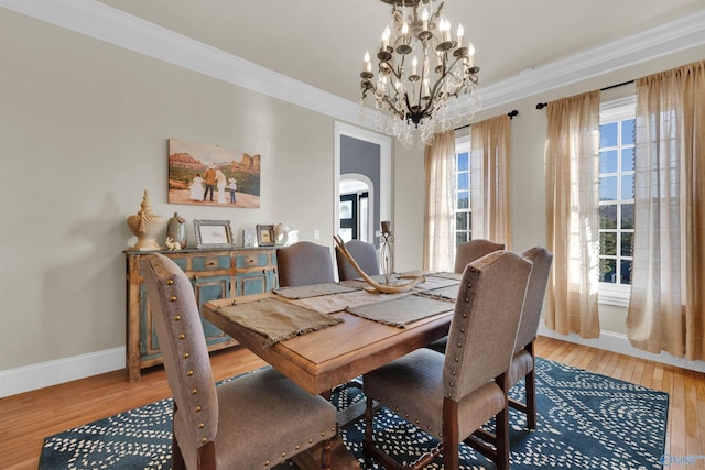 dining space featuring an inviting chandelier, hardwood / wood-style flooring, and ornamental molding