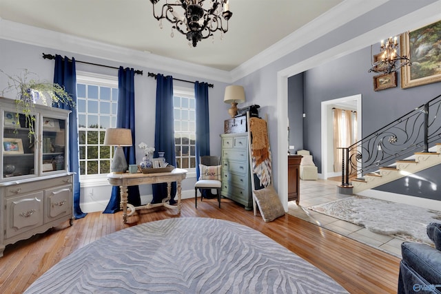 sitting room with ornamental molding, a chandelier, and light hardwood / wood-style floors