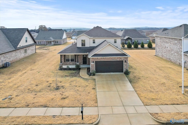 view of front of property featuring a front lawn, a garage, and central AC unit