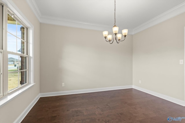 empty room with a chandelier, dark hardwood / wood-style floors, plenty of natural light, and crown molding