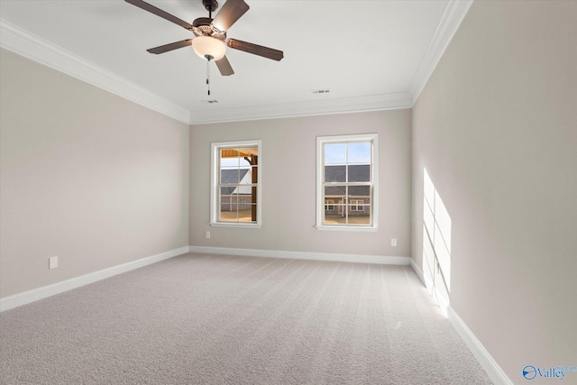 empty room featuring light colored carpet, ceiling fan, and ornamental molding