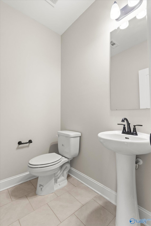 bathroom featuring sink, tile patterned flooring, and toilet