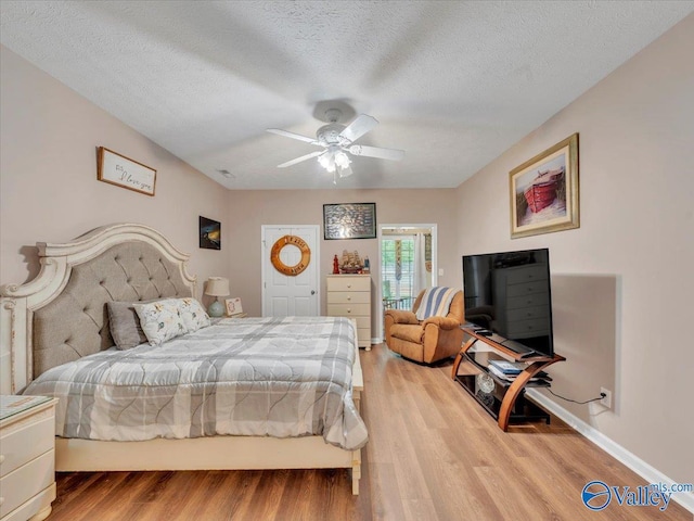 304 Santana Dr, Athens, AL 35611 - bedroom with light wood-style floors, a textured ceiling, a ceiling fan, and baseboards