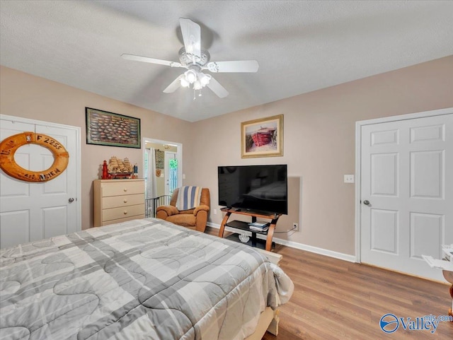 304 Santana Dr, Athens, AL 35611 - bedroom with wood finished floors, baseboards, a ceiling fan, and a textured ceiling