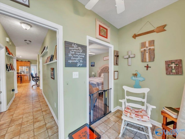304 Santana Dr, Athens, AL 35611 - corridor featuring baseboards, stone tile floors, and a textured ceiling