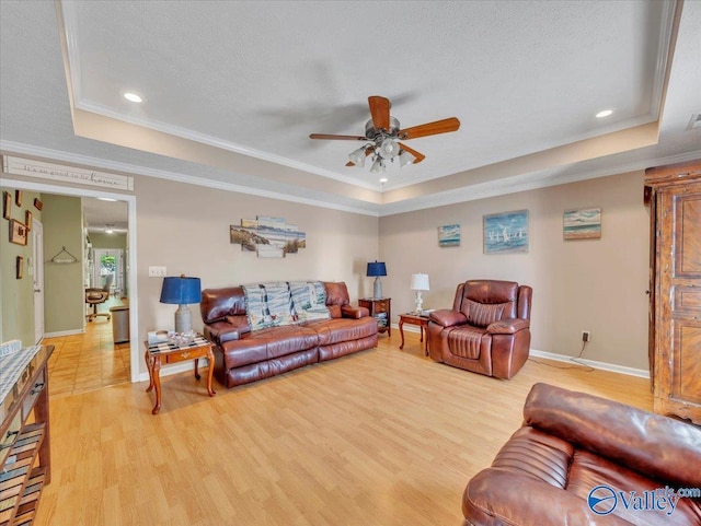 304 Santana Dr, Athens, AL 35611 - living area with a tray ceiling, ceiling fan, baseboards, light wood-type flooring, and crown molding