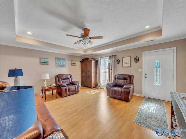 304 Santana Dr, Athens, AL 35611 - living area with a tray ceiling, a textured ceiling, light wood-type flooring, ceiling fan, and ornamental molding