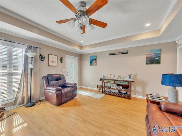304 Santana Dr, Athens, AL 35611 - living area with a raised ceiling, light wood-type flooring, baseboards, a ceiling fan, and ornamental molding