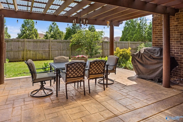 view of patio with a pergola, outdoor dining area, a fenced backyard, and a grill