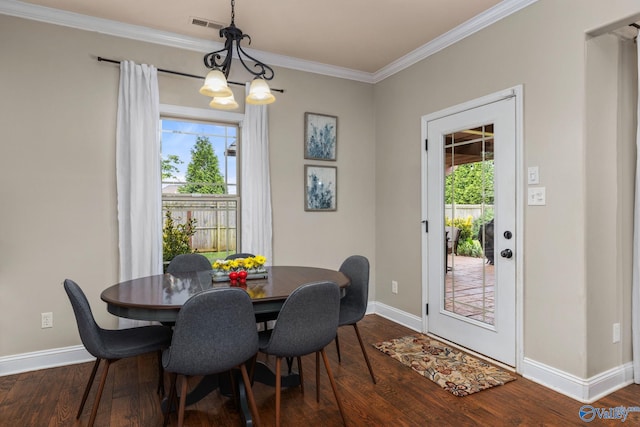 dining room with dark wood finished floors, baseboards, and crown molding