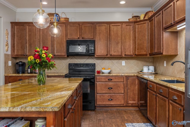 kitchen featuring black appliances, a sink, dark wood-type flooring, crown molding, and light stone counters