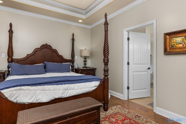 bedroom with wood finished floors, crown molding, recessed lighting, and baseboards