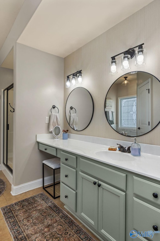 bathroom with vanity, baseboards, a stall shower, and tile patterned flooring