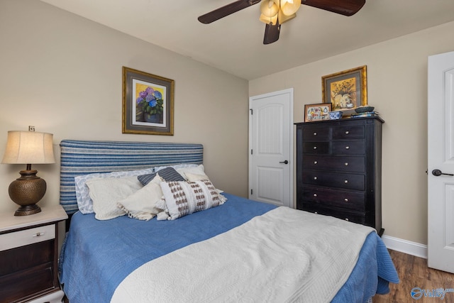 bedroom featuring wood finished floors, baseboards, and ceiling fan