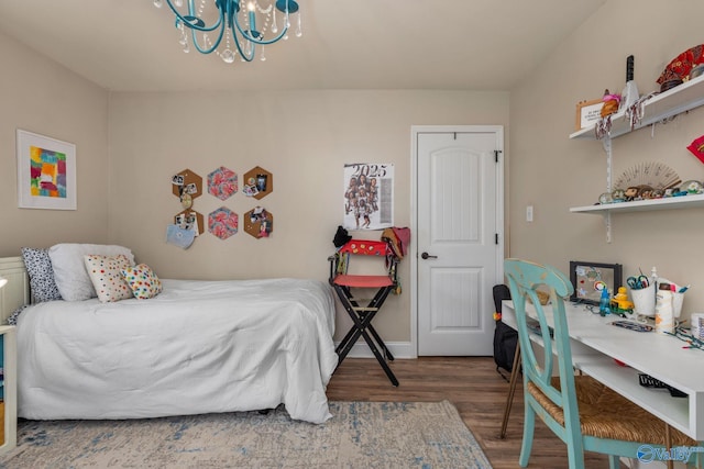 bedroom featuring wood finished floors and a chandelier