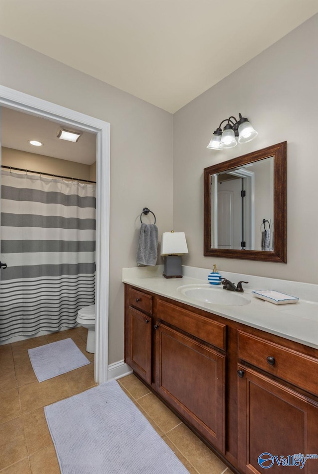 bathroom with tile patterned flooring, toilet, and vanity