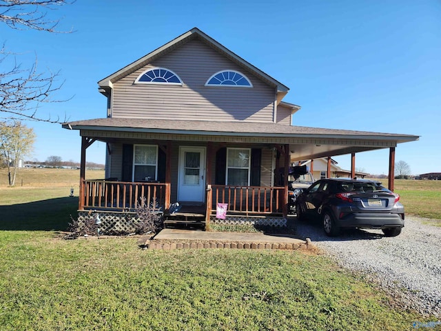 farmhouse with a carport, a porch, and a front yard