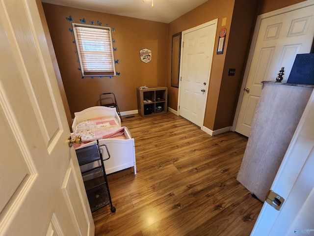 corridor with hardwood / wood-style flooring