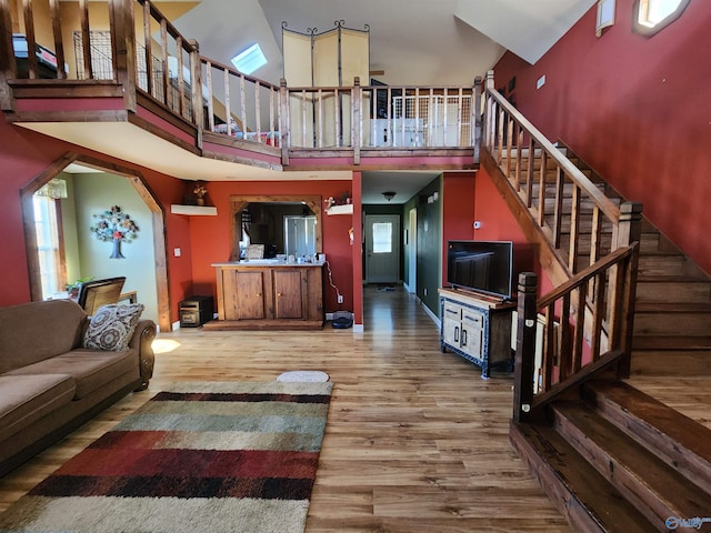 living room with wood-type flooring and a high ceiling