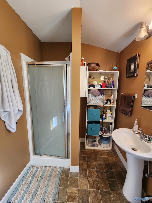 bathroom with lofted ceiling and a shower with shower door
