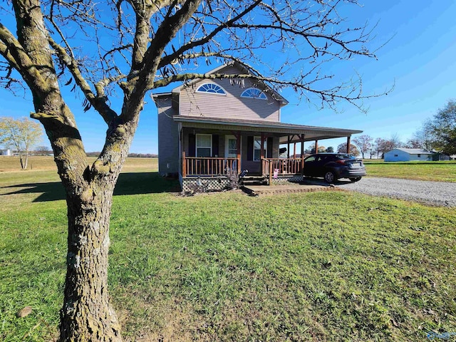 view of front of home with covered porch, a carport, and a front yard
