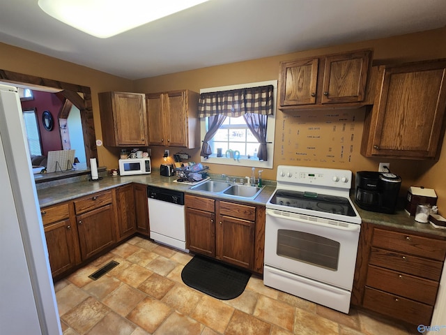 kitchen featuring sink and white appliances