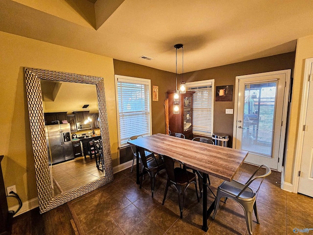 dining space featuring baseboards and visible vents