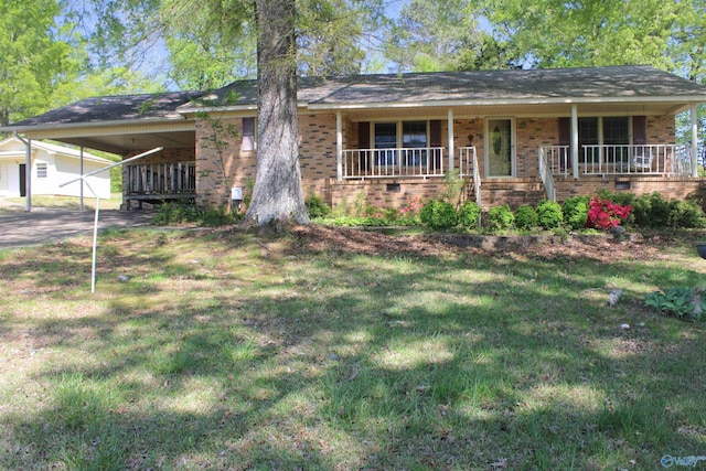 202 Linville St, Scottsboro, AL 35768 - view of front of home featuring brick siding, a front lawn, covered porch, and an attached carport