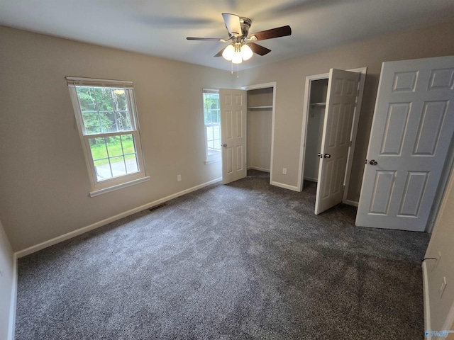 2005 Reaches Pl Unit B, Huntsville, AL 35802 - unfurnished bedroom featuring two closets, dark colored carpet, baseboards, and a ceiling fan