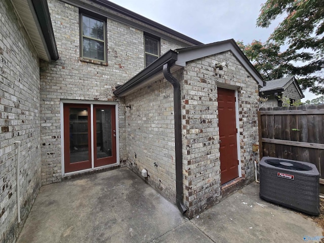 2005 Reaches Pl Unit B, Huntsville, AL 35802 - entrance to property with central AC unit, a patio area, and brick siding