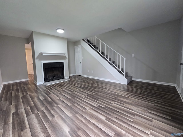 2005 Reaches Pl Unit B, Huntsville, AL 35802 - unfurnished living room featuring wood finished floors, baseboards, stairs, and a fireplace with raised hearth