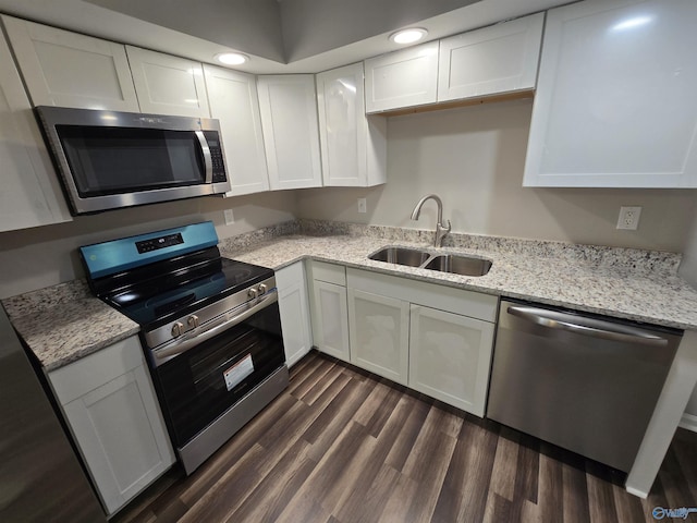 2005 Reaches Pl Unit B, Huntsville, AL 35802 - kitchen with appliances with stainless steel finishes, a sink, white cabinetry, dark wood-style flooring, and light stone counters