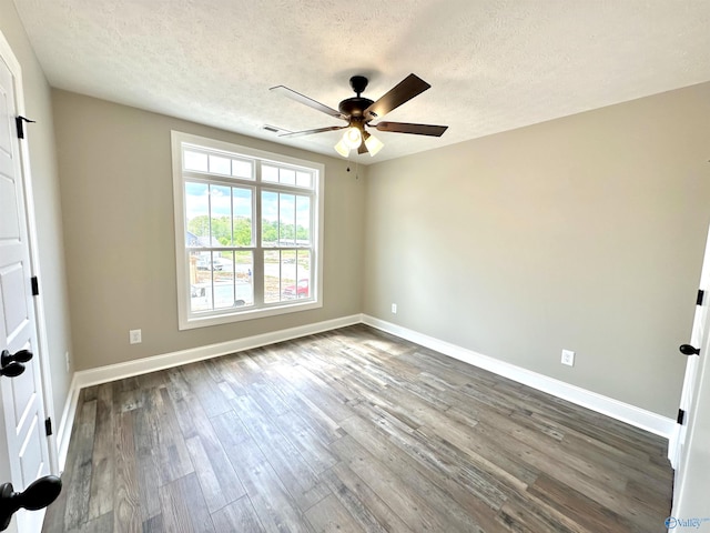 unfurnished bedroom with dark wood-style floors, baseboards, and a textured ceiling