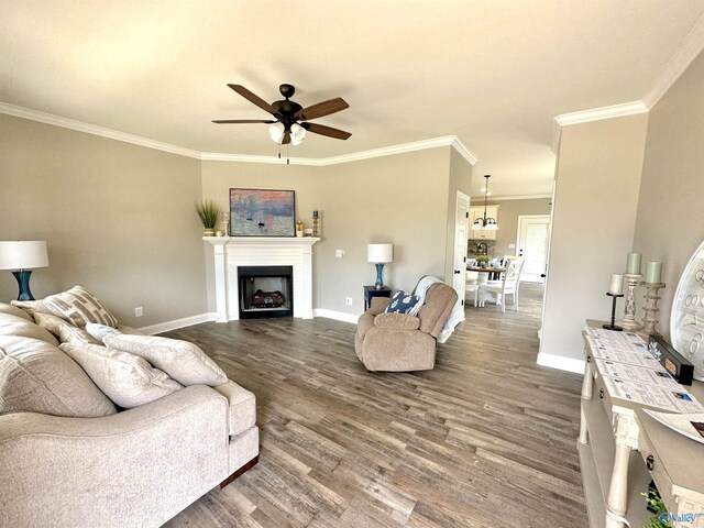 living room featuring ceiling fan, dark wood-type flooring, and ornamental molding