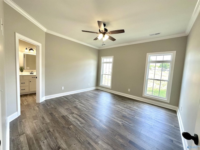 unfurnished bedroom with multiple windows, visible vents, dark wood finished floors, and crown molding