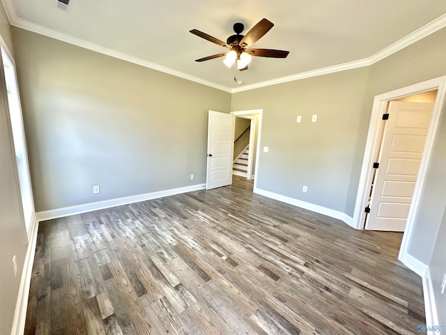 unfurnished bedroom featuring ornamental molding, ceiling fan, baseboards, and wood finished floors