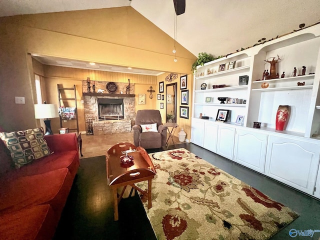 living room with a stone fireplace and lofted ceiling