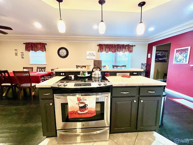 kitchen with light tile patterned floors, stainless steel stove, hanging light fixtures, ornamental molding, and a kitchen island